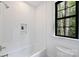 Well lit bathroom features white subway tile, a built-in niche, and a black framed window at 7011 Chateau Bordeaux Ln, Charlotte, NC 28270
