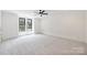 Spacious bedroom with plush carpet, large windows, and trim at 7011 Chateau Bordeaux Ln, Charlotte, NC 28270