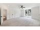 Large bedroom featuring neutral carpet, white trim and doors, and large windows at 7011 Chateau Bordeaux Ln, Charlotte, NC 28270