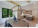 Dining area featuring a modern light fixture, dark wood table, and views of the backyard at 7011 Chateau Bordeaux Ln, Charlotte, NC 28270