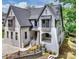 Stunning two-story home featuring a white brick facade, stylish gabled roof, and manicured landscaping at 7011 Chateau Bordeaux Ln, Charlotte, NC 28270