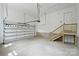 Spacious two-car garage with automatic door, high ceilings, and access stairs at 7011 Chateau Bordeaux Ln, Charlotte, NC 28270