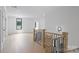Hallway features hardwood floors, trim, and views into the rooms of the home at 7011 Chateau Bordeaux Ln, Charlotte, NC 28270