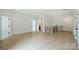 Open hallway featuring hardwood floors and views into the bedrooms and bathroom at 7011 Chateau Bordeaux Ln, Charlotte, NC 28270