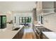 Gourmet kitchen featuring a large island, stainless steel appliances, and an adjacent dining area at 7011 Chateau Bordeaux Ln, Charlotte, NC 28270
