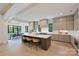 Open-concept kitchen featuring an island with seating, modern cabinets, and a dining area at 7011 Chateau Bordeaux Ln, Charlotte, NC 28270