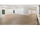 Expansive living room with natural light, hardwood floors, and recessed lighting throughout at 7011 Chateau Bordeaux Ln, Charlotte, NC 28270