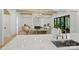Open-concept living room featuring a fireplace, stylish decor, hardwood floors, and modern lighting at 7011 Chateau Bordeaux Ln, Charlotte, NC 28270