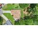 Aerial view of home with spacious backyard, patio with hot tub, and mature landscaping at 7164 Moss Point Dr, Charlotte, NC 28277