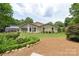 A tranquil backyard offers a patio area, a lush lawn, and meticulously landscaped flower beds, creating a peaceful retreat at 7164 Moss Point Dr, Charlotte, NC 28277