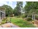 Lush green backyard with shed, mature landscaping, and deck at 7164 Moss Point Dr, Charlotte, NC 28277