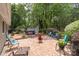 Brick patio with outdoor seating, hot tub, and mature trees in the backyard at 7164 Moss Point Dr, Charlotte, NC 28277