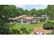 Spacious backyard with a well-maintained lawn, garden beds, a patio, and mature trees providing shade and privacy at 7164 Moss Point Dr, Charlotte, NC 28277