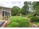 Lush green backyard featuring a garden and mature trees at 7164 Moss Point Dr, Charlotte, NC 28277