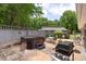 Backyard deck with hot tub, seating, and grill at 7164 Moss Point Dr, Charlotte, NC 28277