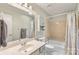 Bathroom featuring a vanity with sink, mirrored cabinet, and tub/shower combo with updated fixtures at 7164 Moss Point Dr, Charlotte, NC 28277