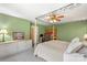 Bedroom featuring a four-poster bed, ceiling fan and built-in desk area with cabinets at 7164 Moss Point Dr, Charlotte, NC 28277