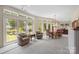 A Dining Room that has multiple windows, wood furniture, and view of the backyard at 7164 Moss Point Dr, Charlotte, NC 28277