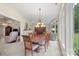 Dining room featuring a wooden dining table with seating and a chandelier at 7164 Moss Point Dr, Charlotte, NC 28277