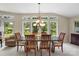 Dining Room with a view of the back yard and a wooden table and chairs at 7164 Moss Point Dr, Charlotte, NC 28277