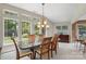 The Dining Room has a view of the outside with large bright windows and a granite table at 7164 Moss Point Dr, Charlotte, NC 28277