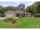 Attractive single-story home with a well-manicured lawn and appealing landscaping at 7164 Moss Point Dr, Charlotte, NC 28277