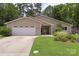 Charming single-story home with an attached garage and a well-manicured front lawn at 7164 Moss Point Dr, Charlotte, NC 28277