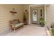 Inviting covered front porch featuring a bench, shelves, and a decorative wreath on the door at 7164 Moss Point Dr, Charlotte, NC 28277