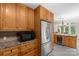 This Kitchen has a stainless steel refrigerator, microwave, and wooden cabinets at 7164 Moss Point Dr, Charlotte, NC 28277