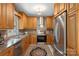 Well-equipped kitchen featuring stainless steel appliances, custom cabinets, and an ornate rug at 7164 Moss Point Dr, Charlotte, NC 28277