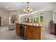 A kitchen island featuring wooden cabinets and a wine cooler at 7164 Moss Point Dr, Charlotte, NC 28277
