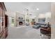 Spacious living room features a stone fireplace, plush seating, and neutral-toned carpet at 7164 Moss Point Dr, Charlotte, NC 28277
