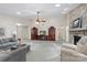 Expansive living room with stone fireplace, TV cabinet, and plush seating for relaxation at 7164 Moss Point Dr, Charlotte, NC 28277