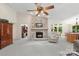 Comfortable living room with a stone fireplace and open access to the dining area at 7164 Moss Point Dr, Charlotte, NC 28277