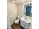 Compact bathroom with vanity sink and toilet; vinyl flooring at 7812 Old Concord Rd, Salisbury, NC 28146