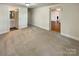 Spacious carpeted bedroom with ensuite bathroom and view into another room at 7812 Old Concord Rd, Salisbury, NC 28146