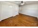 Bedroom features hardwood floors, closet with sliding doors and ceiling fan at 7812 Old Concord Rd, Salisbury, NC 28146