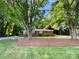 Quaint brick home with front porch and mature shade trees at 7812 Old Concord Rd, Salisbury, NC 28146
