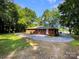 Well-maintained home with a paved driveway and green lawn surrounded by trees at 7812 Old Concord Rd, Salisbury, NC 28146