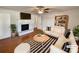 Bright living room with hardwood floors, fireplace, flatscreen TV, and comfy seating area at 7812 Old Concord Rd, Salisbury, NC 28146