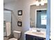 Well-lit bathroom features a vanity, toilet, framed mirror, and glass-enclosed shower at 8388 Waxhaw Hwy, Waxhaw, NC 28173