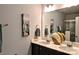 Bathroom featuring double vanity, matching artwork and large framed mirror at 8388 Waxhaw Hwy, Waxhaw, NC 28173