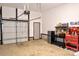 Clean garage with a white door, black trim, overhead lighting, and a red toolbox at 8388 Waxhaw Hwy, Waxhaw, NC 28173