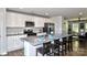 Bright kitchen featuring a granite countertop island with seating, stainless appliances, and ample cabinet space at 8388 Waxhaw Hwy, Waxhaw, NC 28173