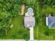 Aerial view of home with a pool, nice lawn, mature trees, and a long driveway at 9801 Blackbird Hill Ln, Mint Hill, NC 28227