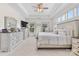 Well-lit bedroom with matching dressers, a bed, windows, and ceiling fan at 9801 Blackbird Hill Ln, Mint Hill, NC 28227