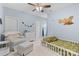 Light blue ' bedroom featuring a toddler bed, arm chair, and charming decor at 9801 Blackbird Hill Ln, Mint Hill, NC 28227
