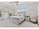 Bright bedroom with a tray ceiling, large bed, and natural light at 9801 Blackbird Hill Ln, Mint Hill, NC 28227