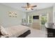 Bright bedroom with large window, ceiling fan, desk, and decorative wall art at 9801 Blackbird Hill Ln, Mint Hill, NC 28227