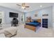 Spacious bedroom with a desk, TV, wood bed frame, and an open layout at 9801 Blackbird Hill Ln, Mint Hill, NC 28227